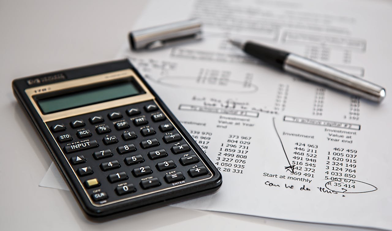 about-us Close-up of financial documents with calculator and pen, ideal for business management themes.